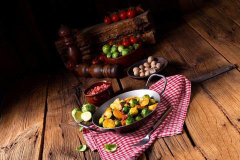Brussels sprouts potato pan with bacon in a rustic style