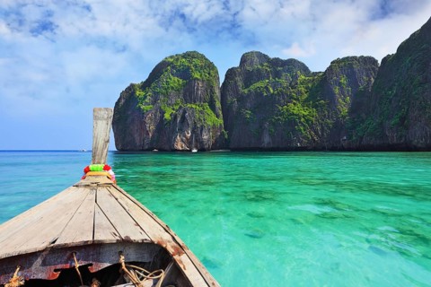 Boat trip on the native boat. Sea water is emerald green and the islands covered with green plants.