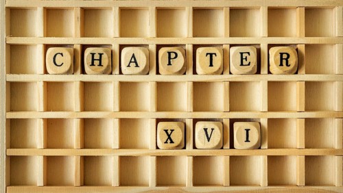 An image of a wooden game with the word chapter sixteen