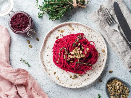Beetroot pesto or hummus. Homemade beet pesto sauce in glass jar and fresh thyme on dark black