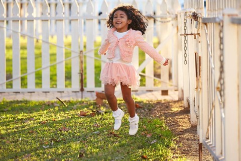 Kid girl toddler playing jumping in park outdoor latin ethnicity
