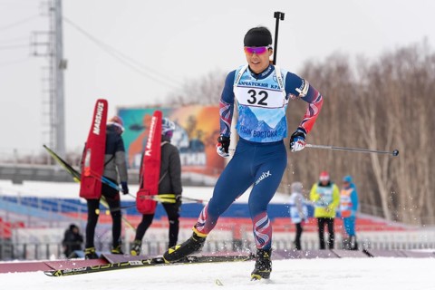 Korean sportsman biathlete Yang Seon Jik skiing on snow distance biathlon stadium during Junior