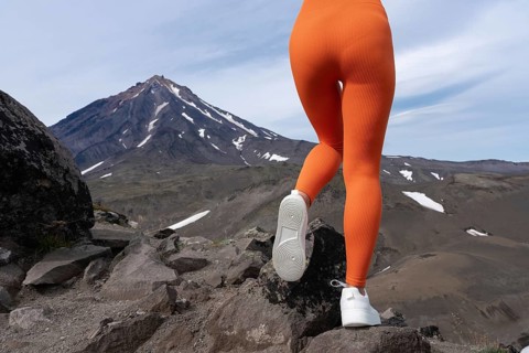 Closeup woman in figure hugging sports leggings showing off buttocks and legs. Athletic woman doing
