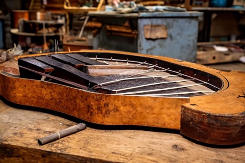 Interior of an old musical workshop with musical instruments and tools