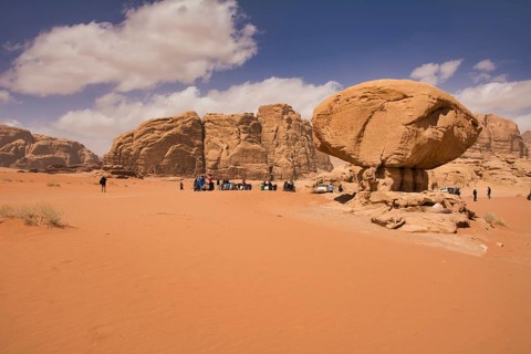 Wadi Rum desert, Jordan, March 2020: People gathering around Mushroom Rock in the Wadi Rum desert