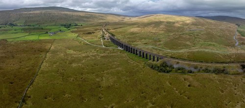 Ribblehead Viaduct, railway viaduct in the Yorkshire Dales, behind Whernside mountain, drone shot,