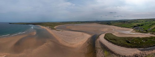 A panorama drone landscape view of the beautiful golden sand beach at Lacken Strand on the coast of