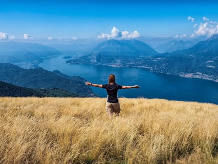 Woman walking in a prairie on Lake Como alps