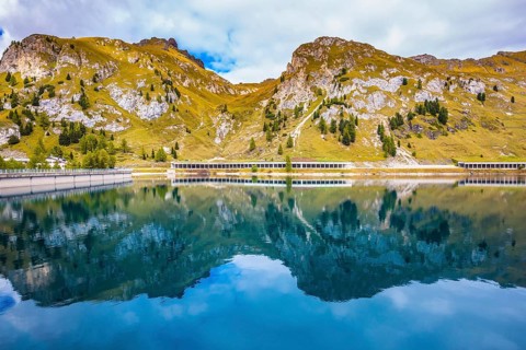 Mountain Lake Lago di Fedadia, Dolomites. Glacial lake with clear cold water. Cool autumn day at