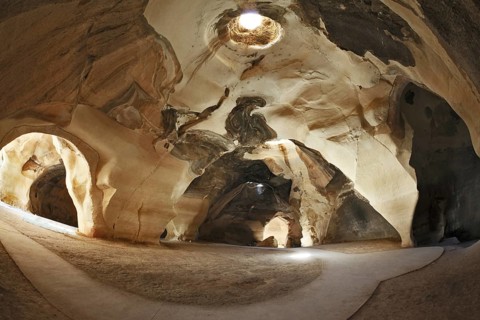 Israel National Park. Bell caves of Beit Guvrin. Picturesque clay arches illuminated by the sun