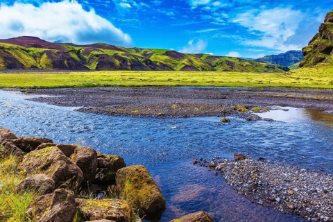 On bottom of canyon many streams flow. Canyon Pakgil in Iceland. Picturesque basalt hills overgrown