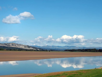 View of the river kent near arnside and sandside in cumbria with surrounding lakeland hills