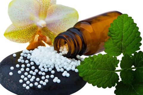 Homeopathy. Globules as alternative medicine. Lying on a stone, Homeopathy. Lying on a stone.