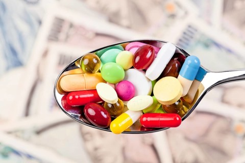 Tablets and Japanese yen currency, symbol of healthcare costs