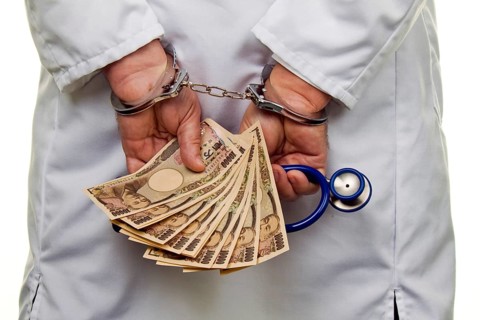 A doctor with Japanese YEN banknotes and handcuffs Austria