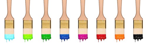 Colourful dropping set of paint brushes in a row isolated on white background