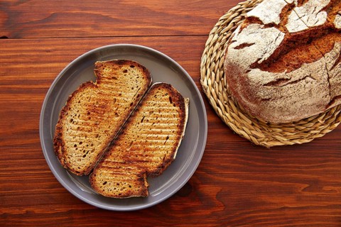 Rye bread toasted slices on dark wooden table top view