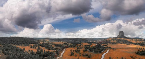 Panoramic aerial view of Devils Tower National Monument at sunset, Wyoming from a drone perspective