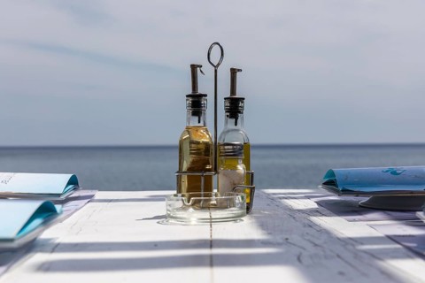 Bottle with vinegar and oil on a restaurant table, Perissa, Santorini Island, Cyclades, Greece,