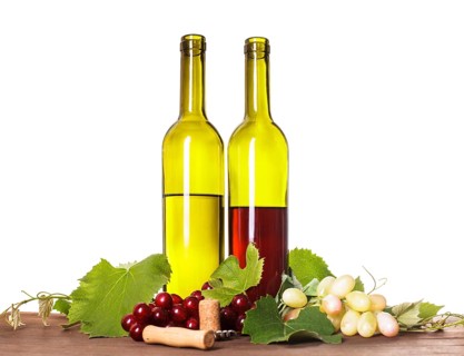 Red and white wine in bottles on the wooden table