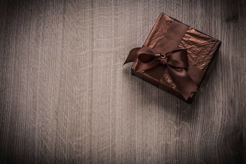 Present boxed in glittery crumpled paper with bow celebration concept