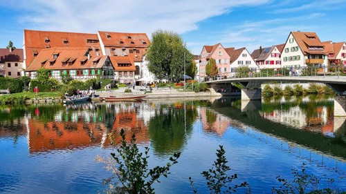 View of the riverside promenade in Rottenburg am Neckar with a punt