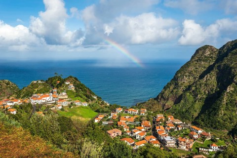 View from the Miradouro de Pastel over the small coastal village of Boaventura with its orange
