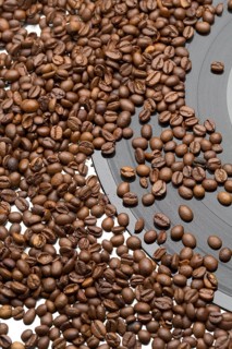 Coffee beans and vintage vinyl record on white background