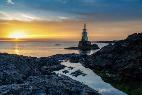 The Athopol Lighthouse on the Black Sea coast of Bulgaria with tidal pools in the foreground at