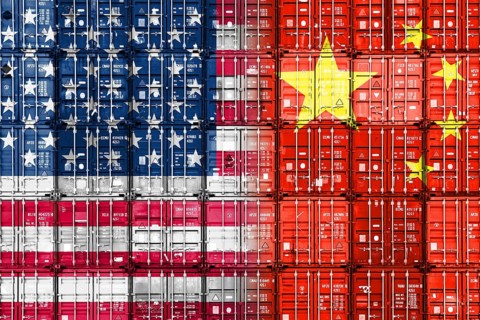 Stacked containers in US and Chinese national colours, symbolic photo of the trade war between the