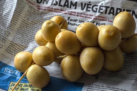 Fresh dates from French vegetables market on newspaper