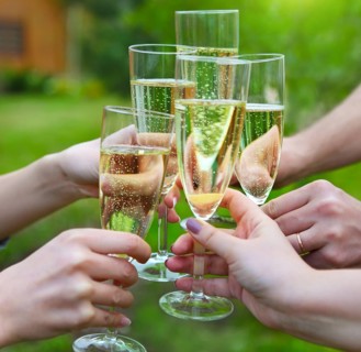 Celebration. People holding glasses of champagne making a toast outdoors
