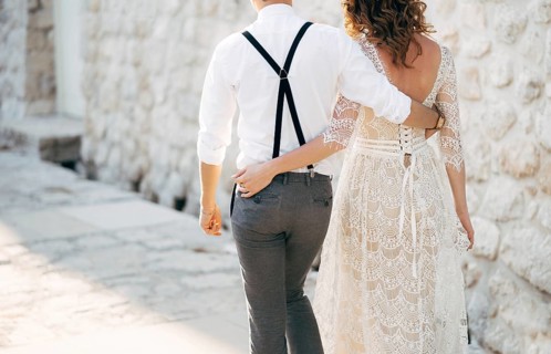 Bride and groom walk along the old pavements of the town. Bottom view.