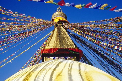 Bodnath Stupa in Nepal decorated with colourful flags