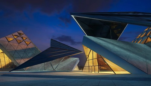 Contemporary triangle shape design modern Architecture building exterior with glass, concrete and