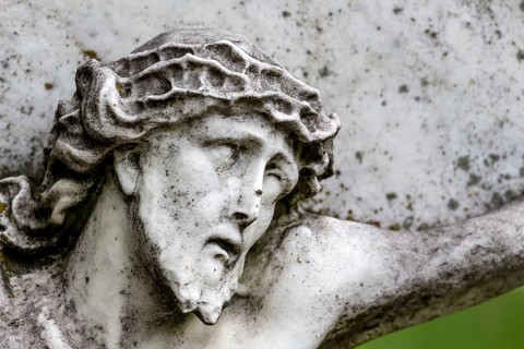 Crucifixion of Jesus on a gravestone in the Barbarafriedhof cemetery in Linz, Austria, Suffering