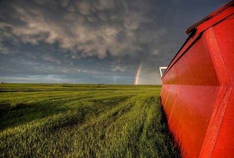 Abandoned Farm with storm clouds in the Canadian Prairie