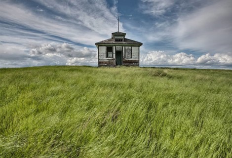 Abandoned Farm with storm clouds in the Canadian Prairie