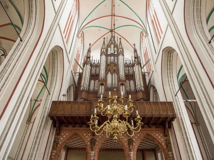 Interior view of a church with a large organ and a chandelier, Gothic architecture, Schwerin,