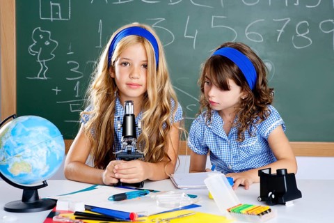 Children girls at school classroom with world map and microscope
