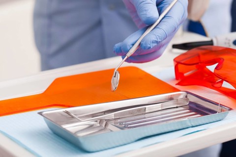 Dental instruments for test the oral cavity and doctor', s hand close up