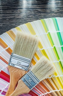 Color pantone fan paint brushes on wooden board top view