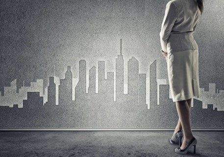 Bottom view of businesswoman and sketches of construction project on wall