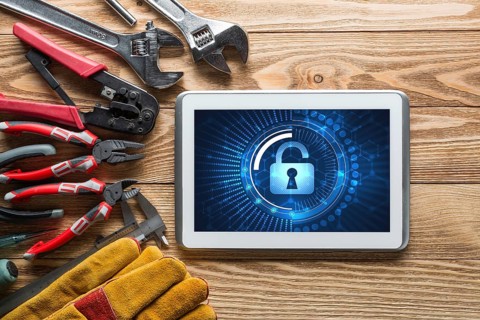 Tablet pc with security concept on screen and industrial tools around