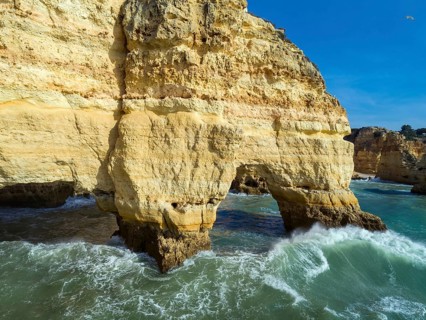 Aerial view on rock cliffs and waves near Praia da Marinha in the Algarve, Portugal, Europe