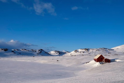 Wooden house on the snowcovered Norwegian mountain plateau Hardangervidda