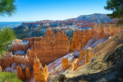 Snow topped Bryce canyon with hoodoos on a sunny day during golden hour, national park, Utah, USA,