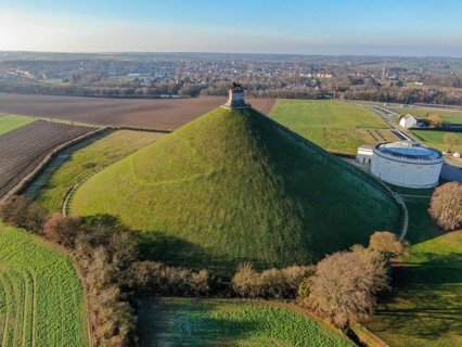 Aerial view of The Lion's Mound with farm land around. The immense Butte Du Lion on the battlefield