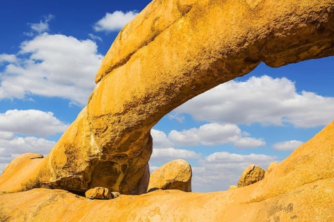 The natural massif of smooth bald granites among the Namib Desert. Stone arch of Spitzkoppe,
