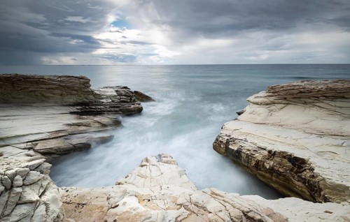 Beautiful Rocky coast with white limestones forming wonderful patterns and waves hitting the rocks.
